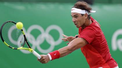 Rafael Nadal, of Spain, returns to Federico Delbonis, of Argentina, at the 2016 Summer Olympics in Rio de Janeiro, Brazil, Sunday, Aug. 7, 2016. (AP Photo/Charles Krupa)